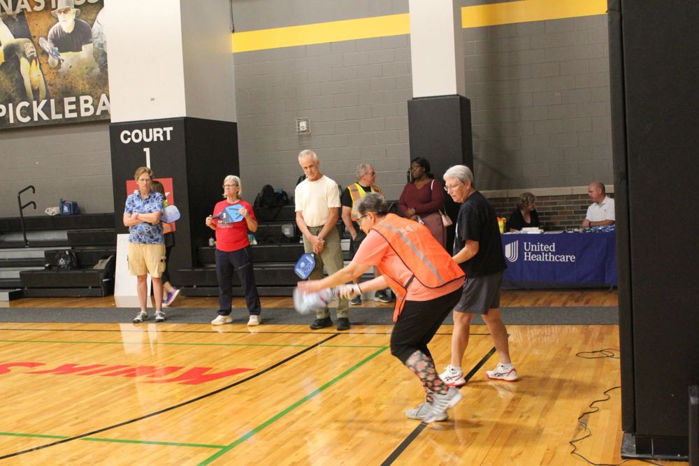 A player lunges for a low ball at the GreenState Family Fieldhouse
